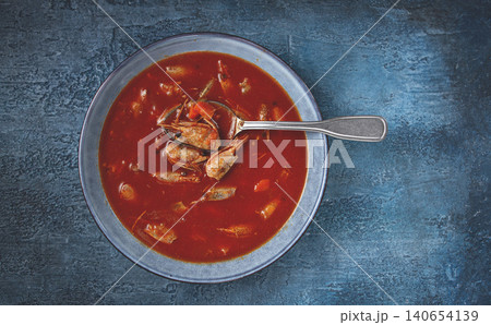 French shrimp bisque soup, in a plate, on a blue background, close-up, no people, French shrimp bisque soup, in a plate, on a blue background, close-up, no people, 140654139