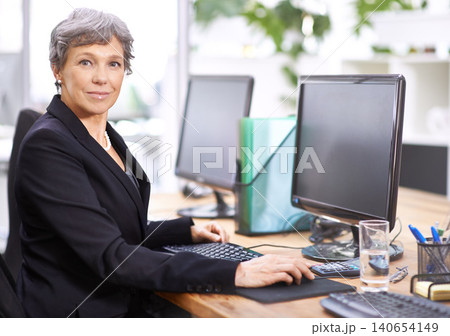 Business woman, portrait and senior professional office manager at a computer with a smile for digital work. Tech, desk and happy executive with online job and confidence from company admin career 140654149