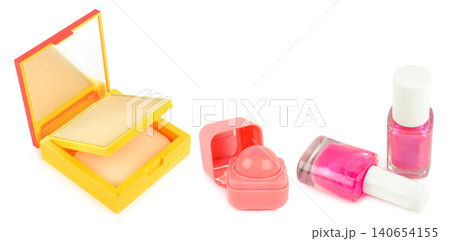 High angle studio shot of decorative cosmetics set including face powder compact, round pink lip balm, and two shiny bottles of pink nail polish isolated on white background, horizontal banner. High angle studio shot of decorative cosmetics set including face powder compact, round pink lip balm, and two shiny bottles of pink nail polish isolated on white background, horizontal banner. 140654155