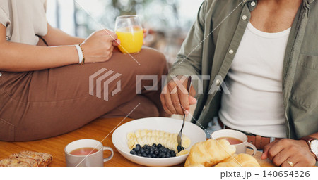 Health, hands and couple eating breakfast with fruit, coffee and juice at table for wellness diet. Food, wellness and closeup of man and woman enjoying brunch meal together in morning at home. 140654326