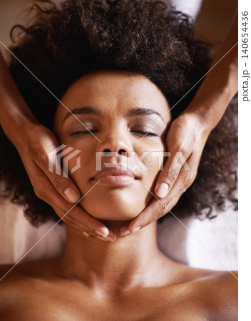 Woman, cosmetics and massage on face with hands and care for facial, spa and beauty treatment on bed. Above, towel and calm african female person with skincare and relax at a hotel with skin glow Woman, cosmetics and massage on face with hands and care for facial, spa and beauty treatment on bed. Above, towel and calm african female person with skincare and relax at a hotel with skin glow 140654436