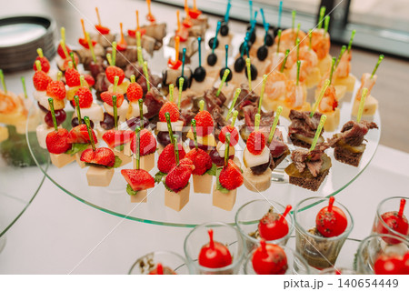 Assorted canapes and finger foods on trays for a holiday buffet Assorted canapes and finger foods on trays for a holiday buffet 140654449