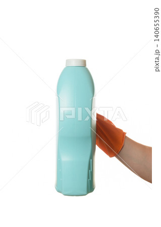 hand in a rubber glove holding a large blue bottle of product hand in a rubber glove holding a large blue bottle of product 140655390
