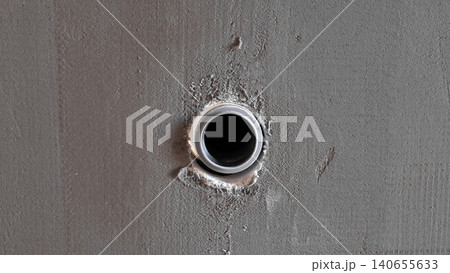 Round Conduit Hole In Wall, Inspector Documenting Penetration During House Construction Closeup Of Circular Opening With Mortar Edges And Raw Plaster Texture, Practical View For Site Round Conduit Hole In Wall, Inspector Documenting Penetration During House Construction Closeup Of Circular Opening With Mortar Edges And Raw Plaster Texture, Practical View For Site 140655633