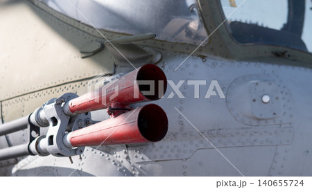 Closeup Rocket Pods On Fuselage, Weathered Paint And Rivets, Three Red Tube Openings, Canopy Edge Visible, Hardpoint Mount And Metal Textures Suggesting Preflight Maintenance Context. Closeup Rocket Pods On Fuselage, Weathered Paint And Rivets, Three Red Tube Openings, Canopy Edge Visible, Hardpoint Mount And Metal Textures Suggesting Preflight Maintenance Context. 140655724