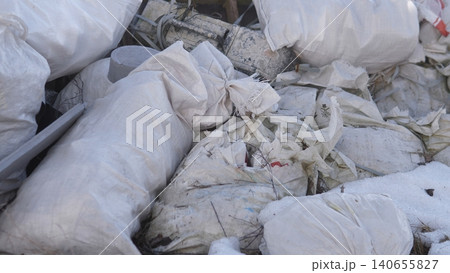Piled Construction Bags, Torn Cement Sacks Scattered Across Dusty Renovation Site, White Woven Textures With Dirt Stains, Collapsed Shapes Forming Cluttered Heap For Disposal, Industrial 140655827