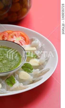 shrimp in fish sauce with Thai spicy seafood dipping sauce on white plate and umeshu 140656728