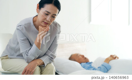 昏睡するシニア男性と悩む女性 昏睡するシニア男性と悩む女性 140656963