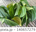 Fresh Green Betel Leaves on Rustic Wooden Background for Traditional Use 140657279
