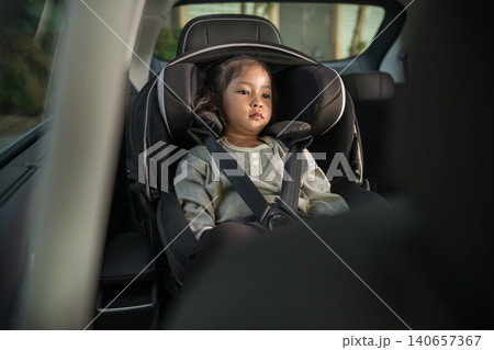 preschool child girl sitting in car seat, safety baby chair travelling preschool child girl sitting in car seat, safety baby chair travelling 140657367