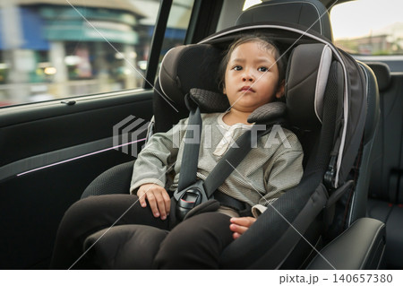 preschool child girl sitting in car seat, safety baby chair travelling preschool child girl sitting in car seat, safety baby chair travelling 140657380