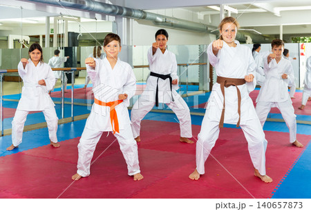 Female trainer is training teenagers in karate class 140657873