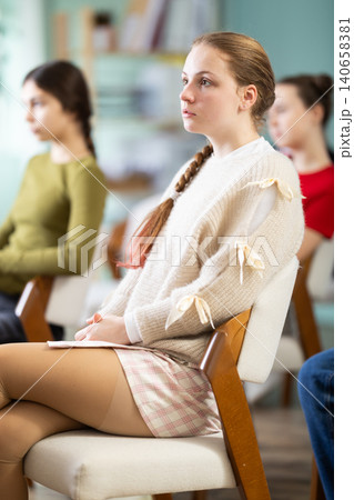 Teen girl attendee group class and listen to lecturer. 140658381