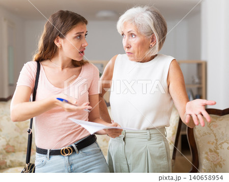 Woman realtor is dissatisfied with the elderly landlady of a rented apartment 140658954