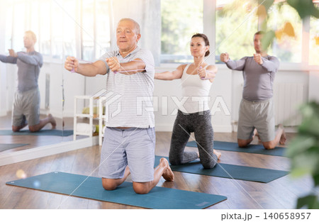 Elderly man exercising with pilates loop 140658957