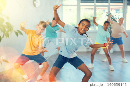 Expressive cheerful african american tween boy practicing hip-hop movements Expressive cheerful african american tween boy practicing hip-hop movements 140659143