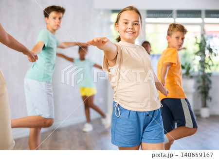 Light-skinned boy and girl dance in pairs and rehearse dance before performing on main floor. Light-skinned boy and girl dance in pairs and rehearse dance before performing on main floor. 140659167