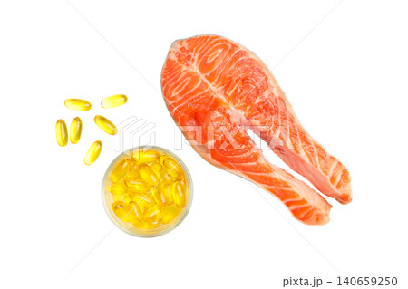 Salmon fillet sits beside a bowl of omega 3 fish oil capsules. Nutritional health concept, PNG 140659250