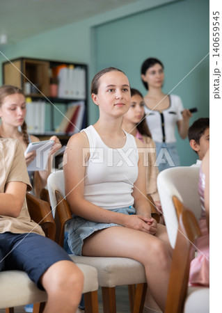 Children and teenagers listening to teacher in classroom Children and teenagers listening to teacher in classroom 140659545