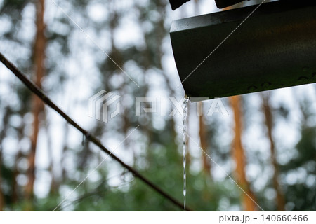 Rainwater Harvesting System Collecting Roof Runoff into Bucket for Sustainable Water Conservation Rainwater Harvesting System Collecting Roof Runoff into Bucket for Sustainable Water Conservation 140660466