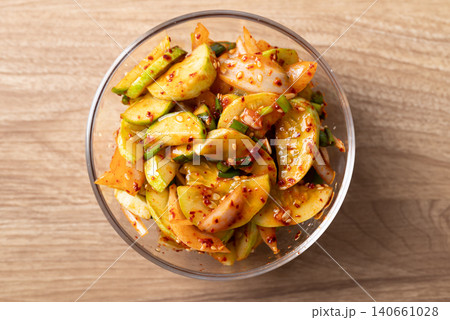 Korean cucumber salad in a glass bowl on wooden background, Table top view Korean cucumber salad in a glass bowl on wooden background, Table top view 140661028