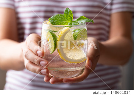 Refreshing iced lemon lime soda in a glass decorated with fresh mint leaves Refreshing iced lemon lime soda in a glass decorated with fresh mint leaves 140661034