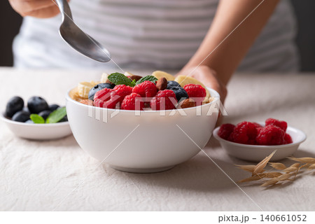 Healthy oatmeal breakfast bowl with raspberry, blueberry, banana and almond ready to eating Healthy oatmeal breakfast bowl with raspberry, blueberry, banana and almond ready to eating 140661052
