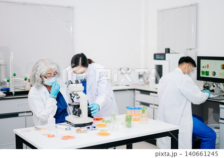 Male nutritionist in lab coat analyzing food and writing in notebook. Healthy eating, organic testing, and nutrition science Male nutritionist in lab coat analyzing food and writing in notebook. Healthy eating, organic testing, and nutrition science 140661245