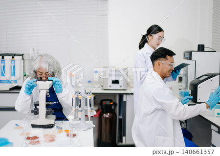 Two Asian Scientists Analyzing Data on Computer Monitor in Modern Laboratory Two Asian Scientists Analyzing Data on Computer Monitor in Modern Laboratory 140661357