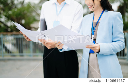 Business professionals reviewing reports and discussing strategy in modern corporate environment, teamwork, partnership, management and office 140661487