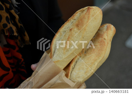 closeup of fresh bread in hands of woman in the street closeup of fresh bread in hands of woman in the street 140663181