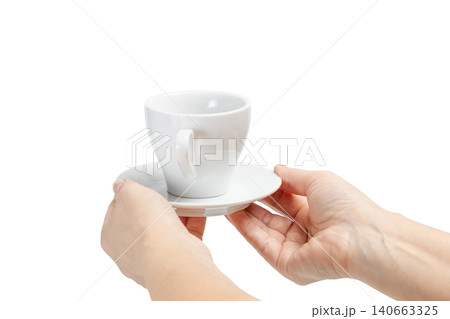Woman holding an empty cup with a saucer on the white isolated background Woman holding an empty cup with a saucer on the white isolated background 140663325