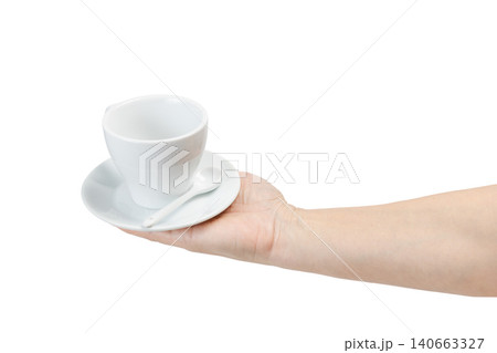 Woman holding an empty cup with a saucer on the white isolated background Woman holding an empty cup with a saucer on the white isolated background 140663327