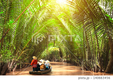 People boating in the delta of Mekong river, Vietnam, Asia. Famous tourist attraction boat ride on Mekong river. Summer vacation, relaxing, topic of travel, trip, cruises, tour 140663456