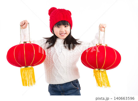Cheerful little Asian girl holding two red lanterns, celebrating Chinese Spring Festival, isolated on white background. Cheerful little Asian girl holding two red lanterns, celebrating Chinese Spring Festival, isolated on white background. 140663596