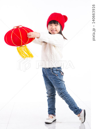 Cheerful little Asian girl holding two red lanterns, celebrating Chinese Spring Festival, isolated on white background. Cheerful little Asian girl holding two red lanterns, celebrating Chinese Spring Festival, isolated on white background. 140663916