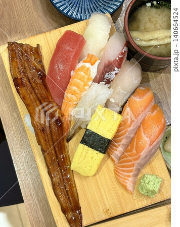 An assortment of fresh sushi, artfully arranged with a variety of toppings and vibrant colors. This traditional Japanese dish combines vinegared rice, seafood, and vegetables for an experience. An assortment of fresh sushi, artfully arranged with a variety of toppings and vibrant colors. This traditional Japanese dish combines vinegared rice, seafood, and vegetables for an experience. 140664524