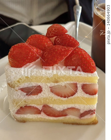 A delectable slice of cake with rich layers of cream and frosting, topped with fresh fruit or sprinkles. Perfect for dessert photography, showcasing indulgence and sweetness in food-related projects. A delectable slice of cake with rich layers of cream and frosting, topped with fresh fruit or sprinkles. Perfect for dessert photography, showcasing indulgence and sweetness in food-related projects. 140664903