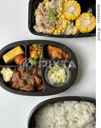 Bento or dosirak box filled with rice, assorted side dishes, vegetables, and protein like meat or fish, all neatly arranged to create a balanced, colorful, and visually appealing meal Bento or dosirak box filled with rice, assorted side dishes, vegetables, and protein like meat or fish, all neatly arranged to create a balanced, colorful, and visually appealing meal 140664906