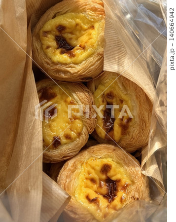 Golden egg tart with a flaky, buttery crust and a rich, creamy custard center. A deliciously satisfying treat for dessert or a light snack, blending texture and flavor perfectly. Golden egg tart with a flaky, buttery crust and a rich, creamy custard center. A deliciously satisfying treat for dessert or a light snack, blending texture and flavor perfectly. 140664942