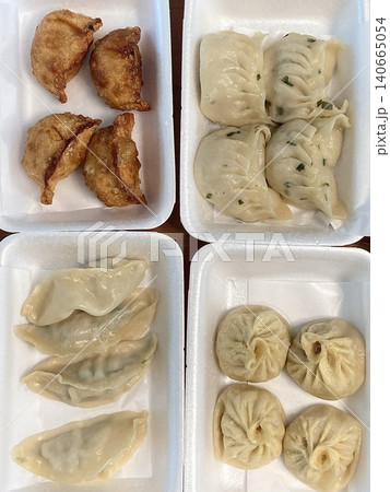 Korean dumplings filled with a mix of savory ingredients like ground meat, tofu, and vegetables. Mandu can be steamed, boiled, or pan-fried, making it a versatile and delicious snack or meal. 140665054