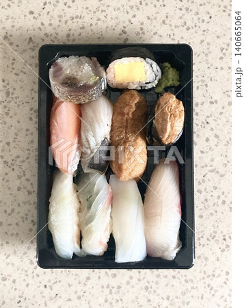 An assortment of fresh sushi, artfully arranged with a variety of toppings and vibrant colors. This traditional Japanese dish combines vinegared rice, seafood, and vegetables for an experience. An assortment of fresh sushi, artfully arranged with a variety of toppings and vibrant colors. This traditional Japanese dish combines vinegared rice, seafood, and vegetables for an experience. 140665064