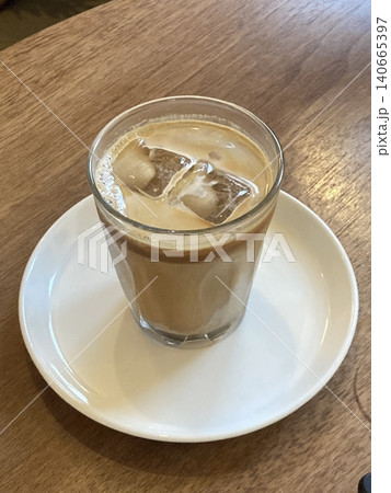 Refreshing iced latte with creamy milk and rich espresso, served over ice for a smooth and invigorating taste. Perfect for coffee lovers who enjoy a cool and energizing pick-me-up! Refreshing iced latte with creamy milk and rich espresso, served over ice for a smooth and invigorating taste. Perfect for coffee lovers who enjoy a cool and energizing pick-me-up! 140665397