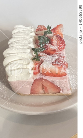 A delectable slice of cake with rich layers of cream and frosting, topped with fresh fruit or sprinkles. Perfect for dessert photography, showcasing indulgence and sweetness in food-related projects. 140665399