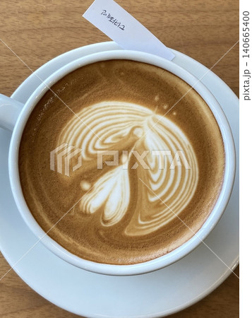 A beautifully crafted latte, featuring creamy foam art on top of rich espresso. Perfect for coffee-related projects, this image captures the warmth and inviting nature of a classic cafe experience. A beautifully crafted latte, featuring creamy foam art on top of rich espresso. Perfect for coffee-related projects, this image captures the warmth and inviting nature of a classic cafe experience. 140665400