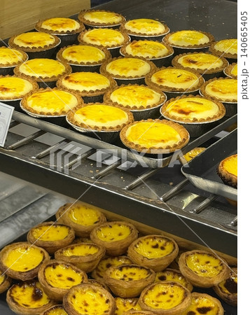 Golden egg tart with a flaky, buttery crust and a rich, creamy custard center. A deliciously satisfying treat for dessert or a light snack, blending texture and flavor perfectly. 140665405