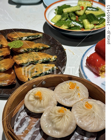 Shumai shrimp with sauce, Steamed shrimp dumplings dim or dim sum and vegetable on wooden table, Cantonese Dimsum food cuisine for breakfast, Chinese traditional food. 140665415
