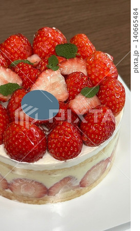 Strawberry cake with soft fluffy layers, topped with fresh strawberries and smooth cream, showcasing vibrant red fruit, delicate textures, and sweet inviting appearance in close-up detail Strawberry cake with soft fluffy layers, topped with fresh strawberries and smooth cream, showcasing vibrant red fruit, delicate textures, and sweet inviting appearance in close-up detail 140665484