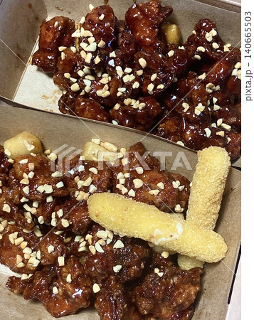 Crispy Korean fried chicken, perfectly glazed with a sweet and spicy sauce. Ideal for food photography and menus, showcasing the irresistible crunch and flavor of this beloved dish. Crispy Korean fried chicken, perfectly glazed with a sweet and spicy sauce. Ideal for food photography and menus, showcasing the irresistible crunch and flavor of this beloved dish. 140665503