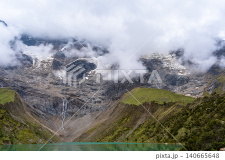 Emerald waters of Laguna Humantay surrounded by Andean mountains in Peru Emerald waters of Laguna Humantay surrounded by Andean mountains in Peru 140665648